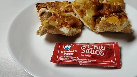 Central Java Indonesia 8 February 2026: Tasty Domino's pizza served with chili s Video stock 332067049