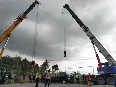 Central Java Indonesia 9 april 2026: Crane truck lifting a fallen cement tanker  Fotos de archivo
