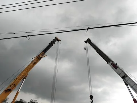 Central Java Indonesia 9 april 2026: Crane truck lifting a fallen cement tanker  Фото