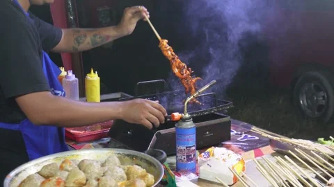 Central Java, Indonesia. April 15,2024: Street seafood seller are cooking Stock Footage 274828581