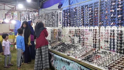 Central Java, Indonesia. April 15,2024: Women are choosing to sell glasses Stock Footage 274829671