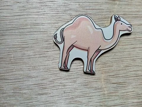 Central Java Indonesia April 17 2024 :Camel animal character toy on a wooden bac Фото