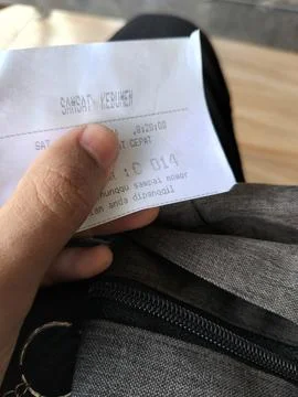 Central Java Indonesia April 29 2026: Close-up of a queue number ticket held by  Fotos Stock