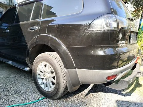 CENTRAL JAVA, INDONESIA - AUG 04, 2026: The rear side view of a black Mitsubishi Stock-Fotos