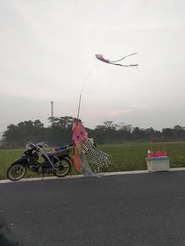Central Java Indonesia AUG 19, 2026: Rural landscape showing a parked motorcycle Fotos de archivo