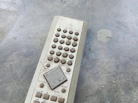 Central Java, Indonesia August 25, 2024: Old remote, on a cement floor. Фото