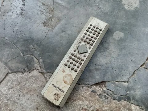 Central Java, Indonesia August 25, 2024: Old remote, on a cement floor. Stockfoto's