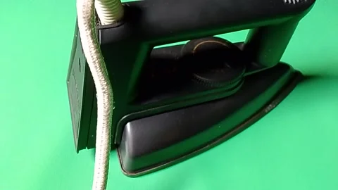 Central Java Indonesia December 28, 2026: Iron on a green background. Stock Footage 325922660