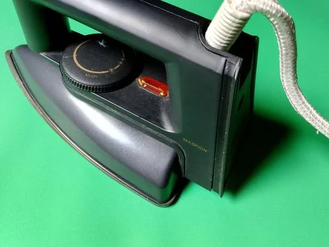 Central Java Indonesia December 28, 2026: Iron on a green background. Фото