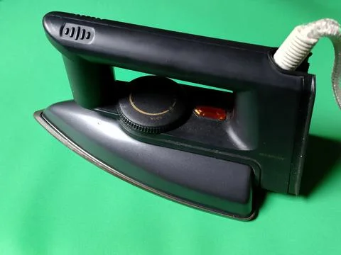 Central Java Indonesia December 28, 2026: Iron on a green background. Stock-Fotos