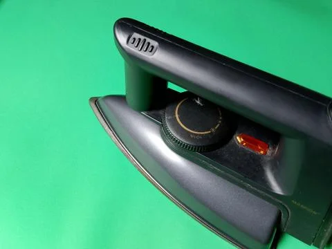 Central Java Indonesia December 28, 2026: Iron on a green background. Фото