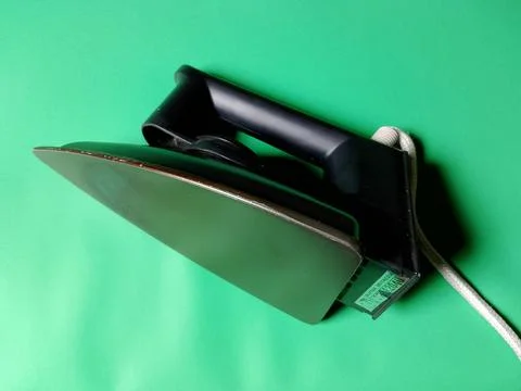 Central Java Indonesia December 28, 2026: Iron on a green background. Stockfoto's