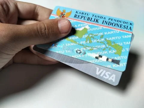 Central Java Indonesia February 15, 2026: A person holding an ID card and a BSI  Фото