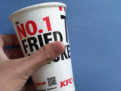 Central Java Indonesia January 11, 2026: Holding kfc drink paper cup. Фото