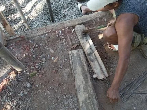Central Java, Indonesia, July 11, 2025: a worker is forming iron for a building  스톡 사진