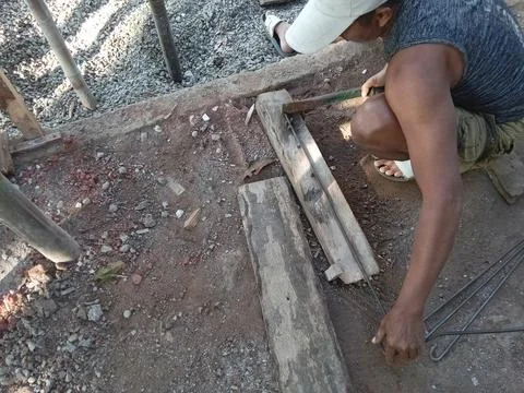 Central Java, Indonesia, July 11, 2025: a worker is forming iron for a building  Fotos Stock