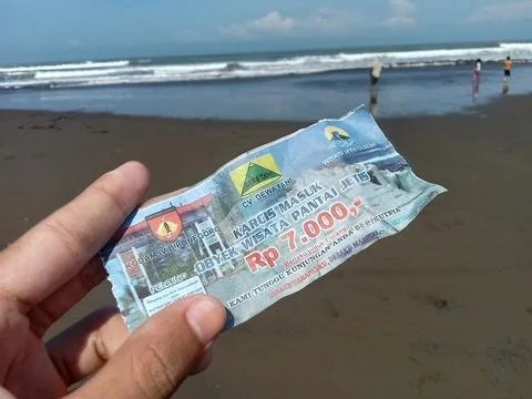 Central Java Indonesia July 7 2024:  Holding an entry ticket for Jetis Beach  Stock-Fotos