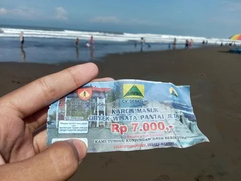 Central Java Indonesia July 7 2024:  Holding an entry ticket for Jetis Beach  Stock-Fotos
