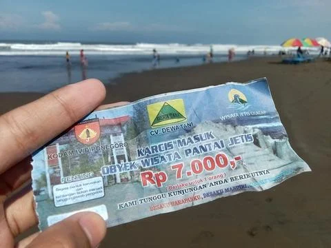 Central Java Indonesia July 7 2024:  Holding an entry ticket for Jetis Beach  Stock-Fotos