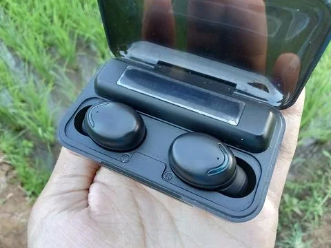 Central Java Indonesia June 10 2024: someone holding a tws audio Фото