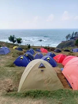 Central Java Indonesia June 18 2024: Camping tents on the Menganti beach hill Stock Photos