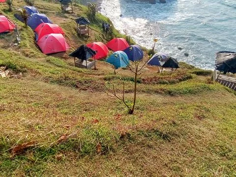 Central Java Indonesia June 18 2024: Camping tents on the Menganti beach hill Фото