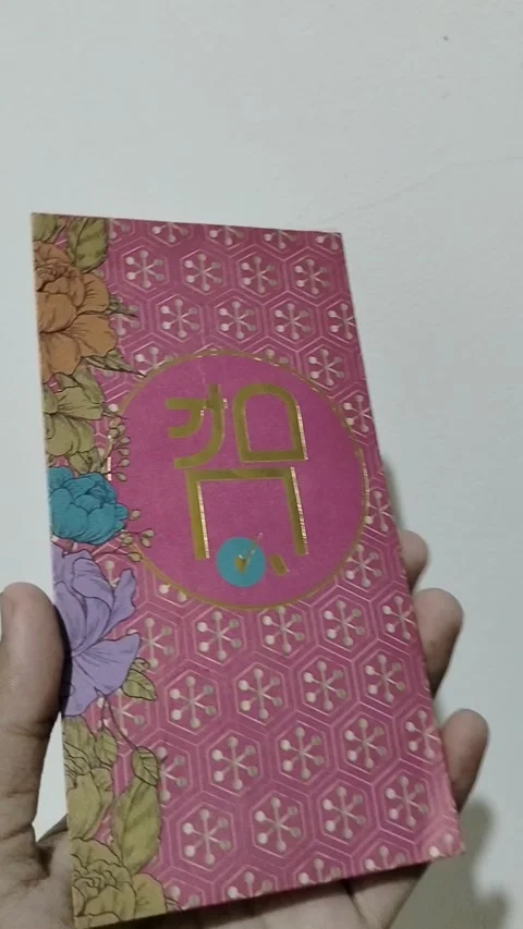 Central Java, Indonesia, March 24, 2026: A person holds a red envelope, a  gift  Stock Footage 332159522