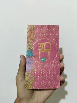 Central Java, Indonesia, March 24, 2026: A person holds a red envelope, a  gift  Stock Photos
