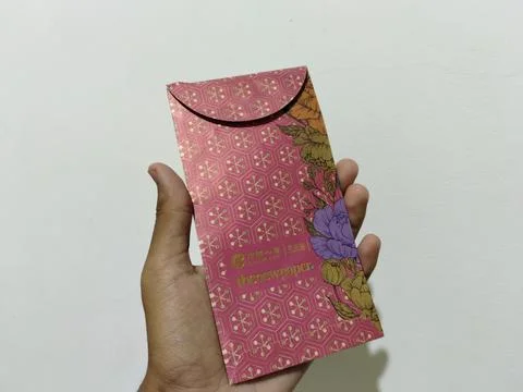 Central Java, Indonesia, March 24, 2026: A person holds a red envelope, a  gift  Stock Photos