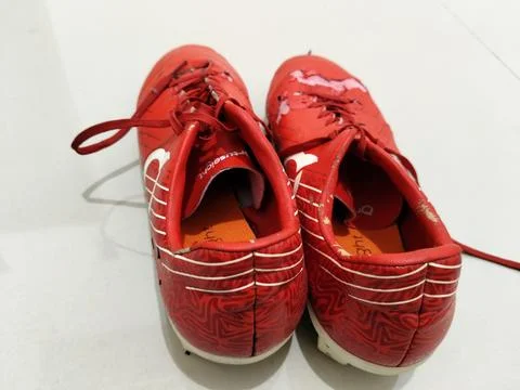 Central Java Indonesia March 28 2026: Close-up of worn red football cleats with  Stock-Fotos