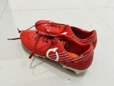 Central Java Indonesia March 28 2026: Close-up of worn red football cleats with  Stock-Fotos