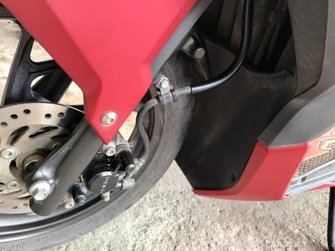 Central Java, Indonesia, March 8, 2026: Detail of automatic motorcycle front whe 库存照片