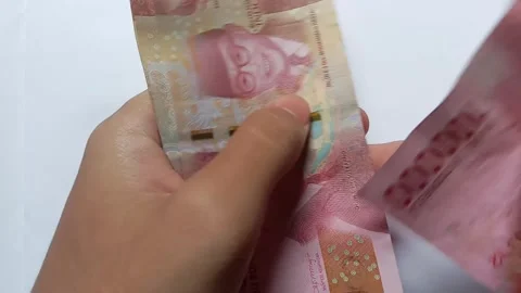 Central Java Indonesia March 9 2021: a person counting banknotes. Stock Footage 274353779