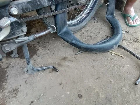 Central Java, Indonesia May 18 2024: A motorbike having its tires repaired, in a Stockfoto's