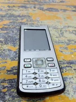 Central Java, Indonesia, October 21, 2025: Feature phone on an abstract table Foto stock