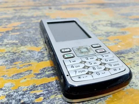 Central Java, Indonesia, October 21, 2025: Feature phone on an abstract table  Фото