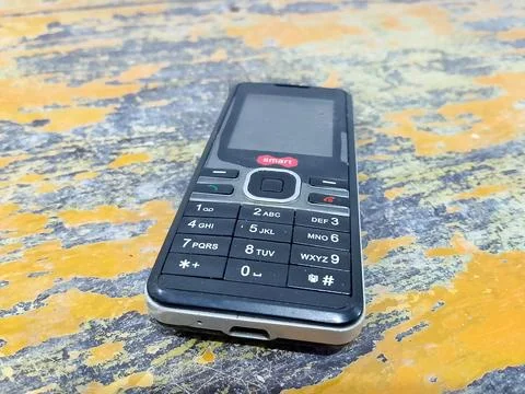 Central Java, Indonesia, October 21, 2025: Feature phone on an abstract table ba Stock-Fotos