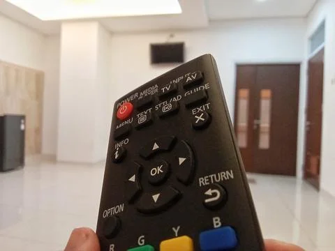 Central Java Indonesia October 3 2024: someone holding a television remote.  Fotos Stock