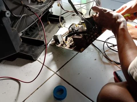 Central Java Indonesia October 7, 2025: an electronics technician is repairing a Stock Photos