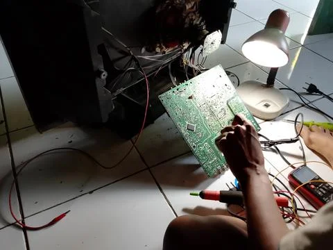 Central Java Indonesia October 7, 2025: an electronics technician is repairing a Фото