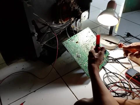 Central Java Indonesia October 7, 2025: an electronics technician is repairing a Stock Photos