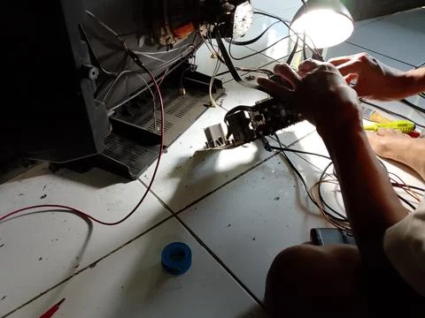 Central Java Indonesia October 7, 2025: an electronics technician is repairing a Stock Photos