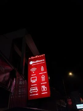 Central Java Indonesia September 18 2026: A bright vertical red neon sign of the 库存照片