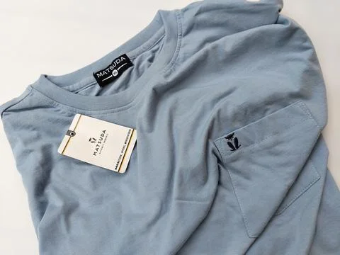 Central Java Indonesia15 July 2026: Light blue crew neck t-shirt with chest pock Stock Photos