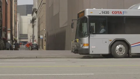Central Ohio Transit Authority Bus Pulling Away from Curb Stock Footage 148702570