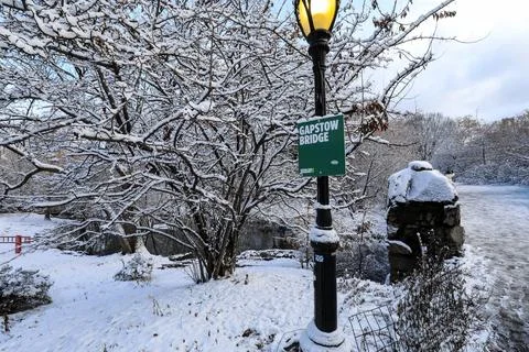 Central Park featuring the Gapstow Bridge sign surrounded by fresh snow Stock Photos