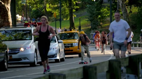 CENTRAL PARK NYC RUNNERS BIKES CARRIAGES SLOW MOTION 02 Stock Footage 41817204