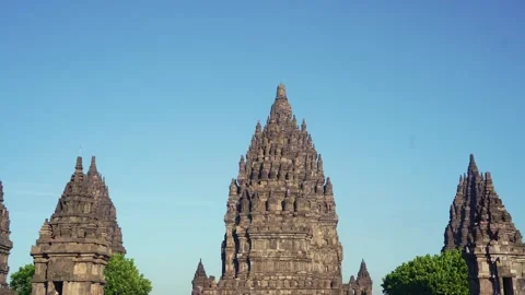 Central Prambanan Temple tower rises between smaller stone spires against a.. Stock Footage 341545112