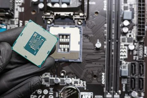 Central processing unit (central processing unit) in a man's hand in a black  Stock Photos