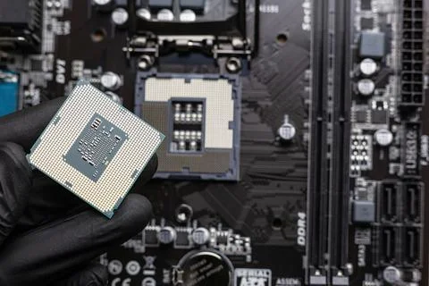 Central processing unit (central processing unit) in a man's hand in a black  Stock Photos
